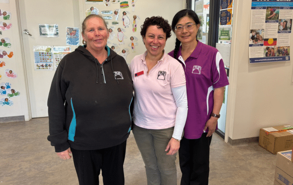 Three Mountain Community Children’s Centre educators standing together inside the Centre.